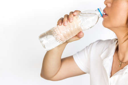 Young woman with bottle of mineral water,isolated on white.
