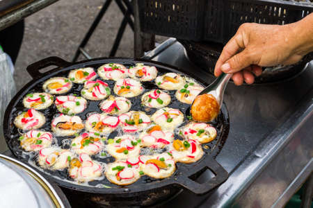 Colorful of seafood fried with shrimps, shellfish on thai ancient pan, Thai food.の写真素材