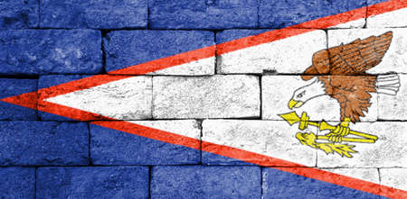 Flag of American Samoa painted over on old brick wall.の写真素材