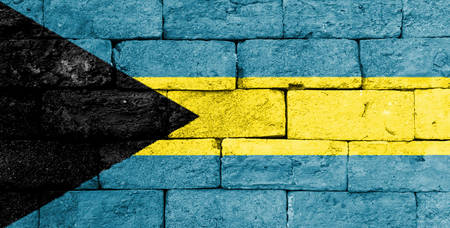 Flag of Bahamas painted over on old brick wall.の写真素材