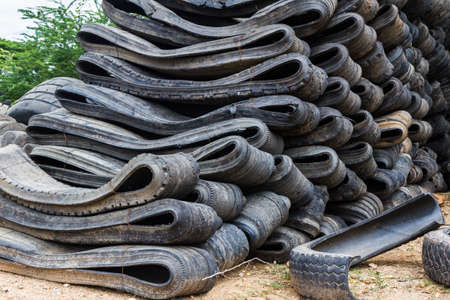 Stack of old wheel black tyre texture background.の写真素材