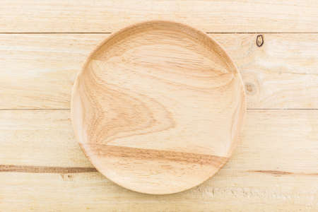 Empty wooden plate on table wood texture background.の写真素材