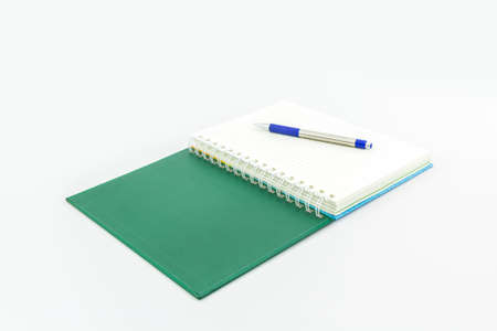 green book with pen on white background.の写真素材