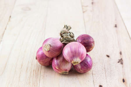 Group of red onion on wood background.の写真素材