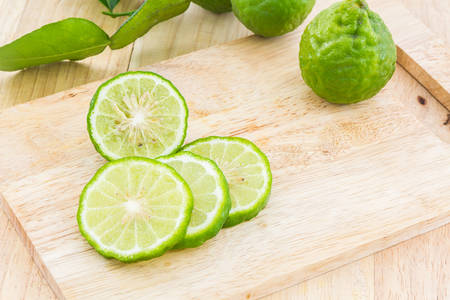 Kaffir Lime (Bergamot) on wooden cutting board.