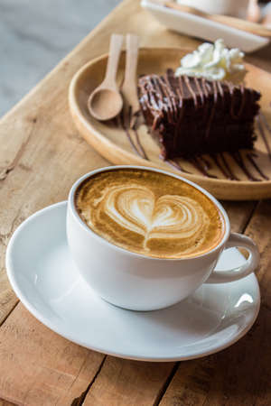 Cappuccino or latte coffee on wooden table.の写真素材