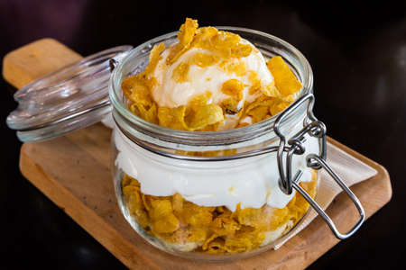 Ice cream and and whipped cream sprinkle cornflake topped with Honey.の写真素材