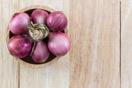 Group of red onion in the wood bowl on wood background,の写真素材