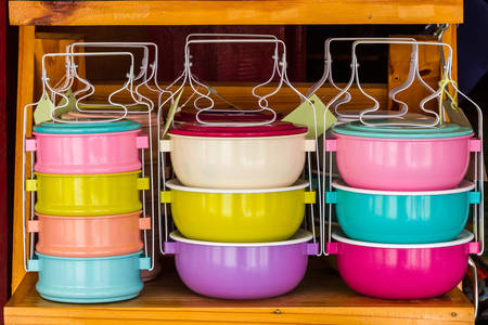 Colorful of tiffin box on shelf for sale.