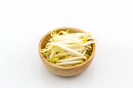 Bean sprout in the wood bowl on white background.の写真素材