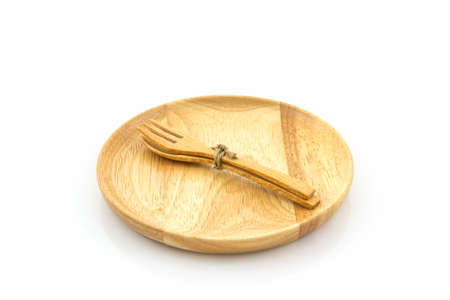 Empty wooden plate and spoons, forks on white  background.の写真素材