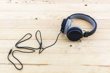 Black Headphones on wood desk Background.の写真素材