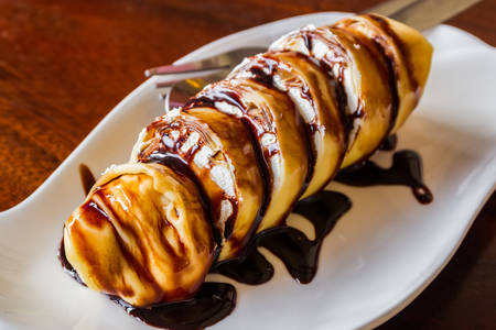 Banana crepe roll and with chocolate sauce.の写真素材