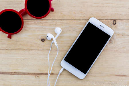 Close up of mobile phone, Smart phone on wooden desk.の写真素材