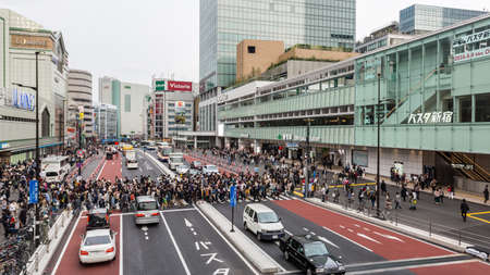 Tokyo, Japan - April 9, 2016: People for street crossing at Shinjuku Express Bus Terminal. The bus...