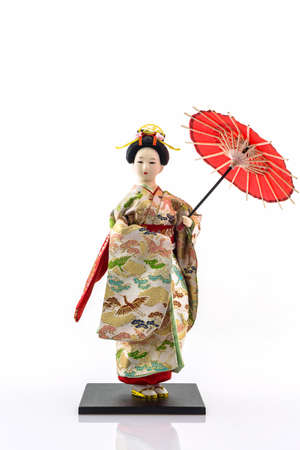 Japanese geisha dolls with japanese umbrella on white background.の写真素材