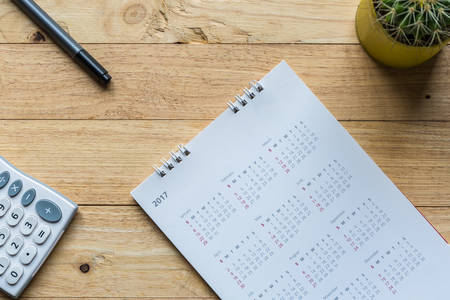 White paper desk spiral calendar 2017 on wood desk Background.の写真素材