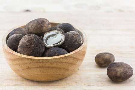 Sliced Barometer Earthstars mushroom in the wood bowl on wood background. Hygroscopic earthstar, False earthstar.の写真素材