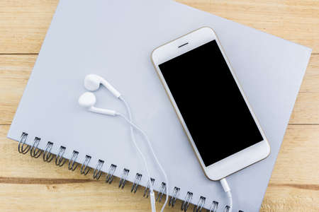 Close up of mobile phone, Smart phone on the spiral notebook.の写真素材