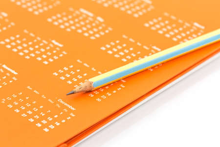 Closeup of calendar page and pencil to mark save the date.の写真素材