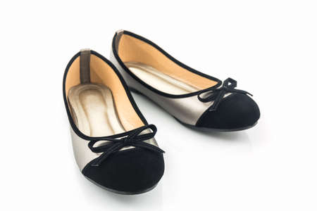 Black and gold color woman shoes isolated on white background.の写真素材