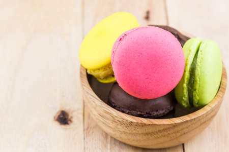 Sweet and colourful french macaroons or macaron on wood background, Dessert.の写真素材