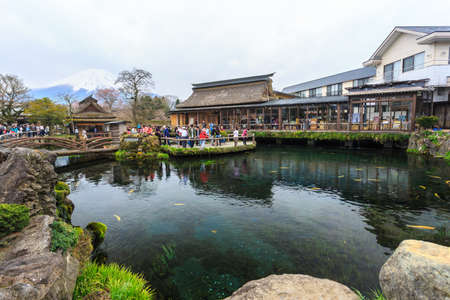 Oshino, Japan - April 10, 2016: Tourists visit Oshino Hakkai, a small village in the Fuji Five Lake region, located between Lake Kawaguchiko and Lake Yamanakako.のeditorial素材