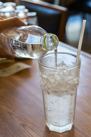 Drinking water pouring from pvc bottle to glass.の写真素材