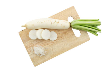 Daikon radishes, Raphanus sativus L on wooden cutting board. 