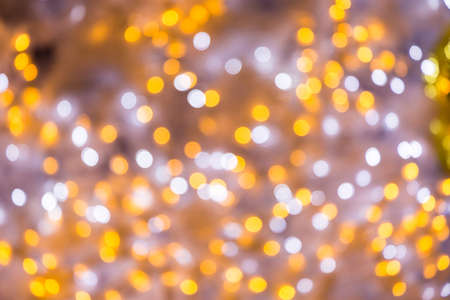 Abstract gold and silver bokeh background. Christmas bokeh lights refocused blurred background.の写真素材