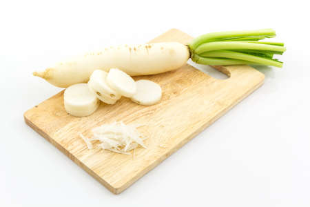 Daikon radishes, Raphanus sativus L on wooden cutting board.