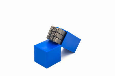 The metal lettering stamps punch set in a plastic box on the white background.の写真素材