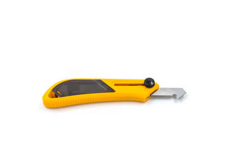 Yellow plastic and laminate cutter knife on white background.の写真素材