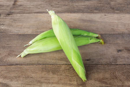 Fresh organic corn on the wood background.の写真素材
