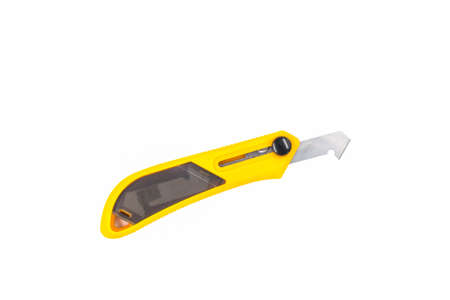 Yellow plastic and laminate cutter knife on white background.の写真素材