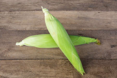 Fresh organic corn on the wood background.の写真素材