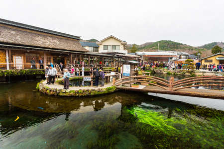 Oshino, Japan - April 10, 2016: Tourists visit Oshino Hakkai, a small village in the Fuji Five Lake region, located between Lake Kawaguchiko and Lake Yamanakako.のeditorial素材