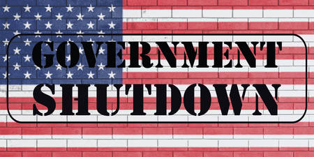 With the word "Govermnent Shutdown" on flag of united states of america painted over on brick wall.の写真素材
