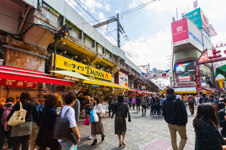Tokyo, Japan - October 20, 2018: Tourists shopping at Ameyoko market in Tokyo Japan.It is a fresh market in the Taito Ward of Tokyo, Japan, located next to Ueno Station.のeditorial素材