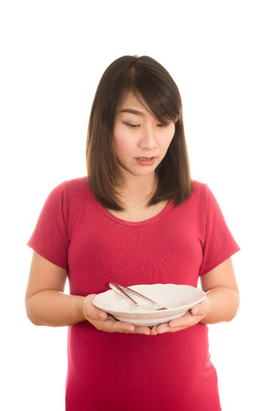 young pregnant woman eating healthy vegetable salad, healthy nutrition and pregnancy isolatedの写真素材