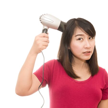 Smiling woman in towel blow-dryの写真素材