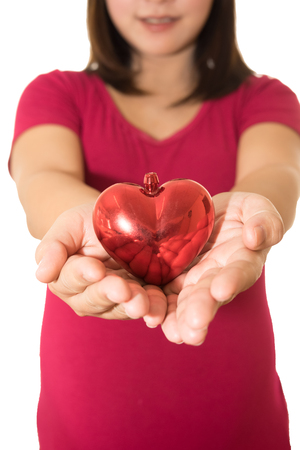 Woman show heart hands isolated on whiteの写真素材