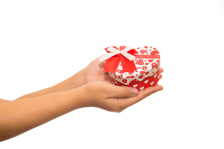Valentine's Day - dreaming cute child with red Heart gift box in hands. isolated on whiteの写真素材