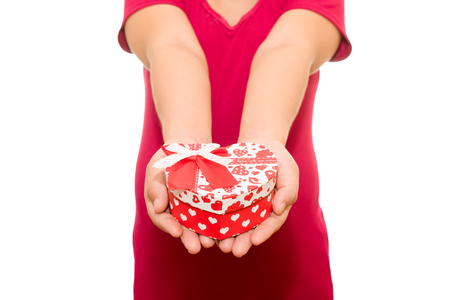 Valentine's Day - dreaming cute child with red Heart gift box in hands. isolated on whiteの写真素材