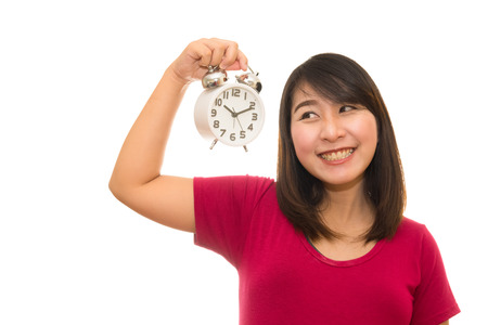Pregnant woman holding wall clock. It's time. Isolated on white.の写真素材