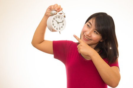 Pregnant woman holding wall clock. It's time. Isolated on white.の写真素材