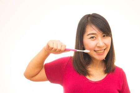 Attractive naked woman with toothbrush. Isolated on white.の写真素材