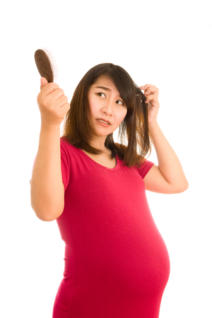 Asian girl pregnant worried about hair loss,Hair lossの写真素材