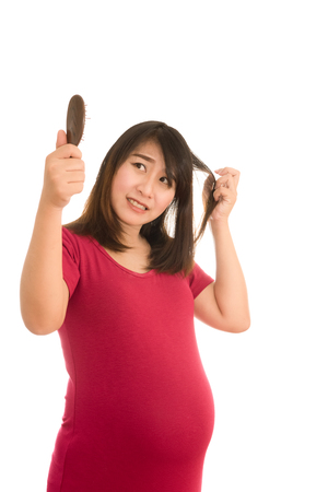 Asian girl pregnant worried about hair loss,Hair lossの写真素材