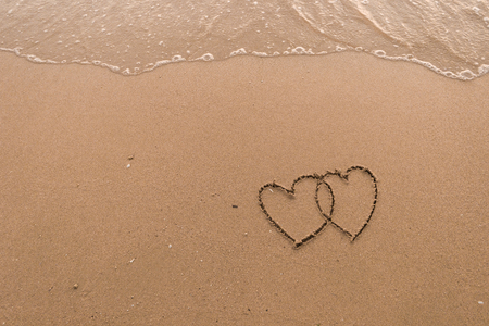 two hearts drawn in beachの写真素材